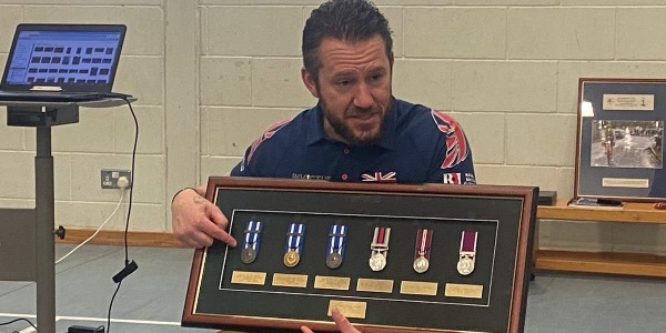 David Jarvis holding his medals