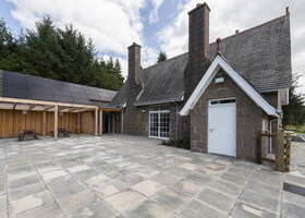 Patio and covered shelter with picnic benches looking over the view