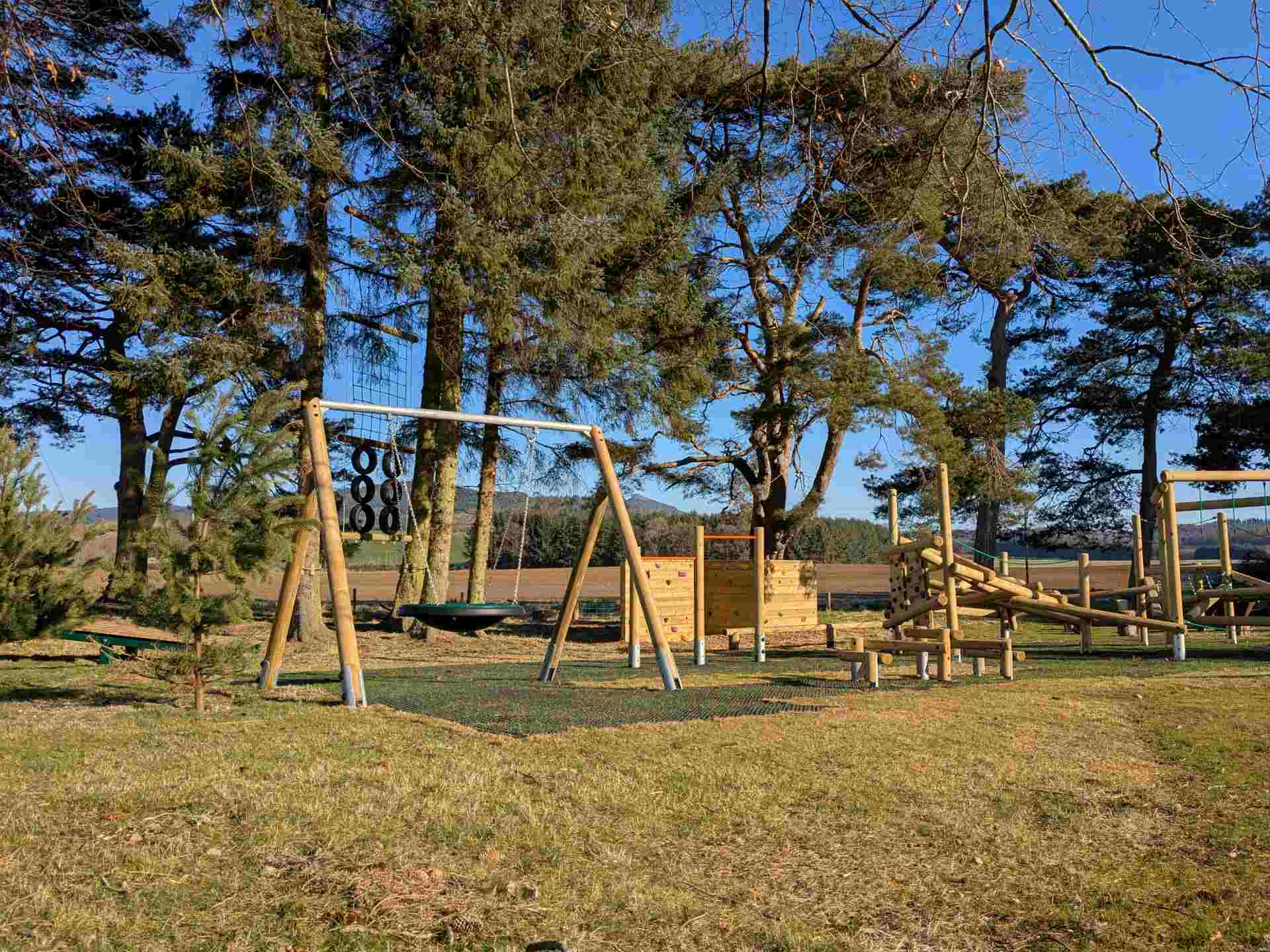 Play equipment including swing and climbing frame