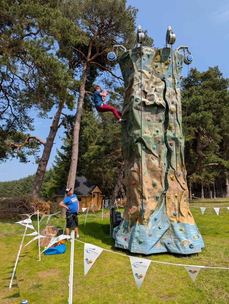 Climbing tower with auto belay system