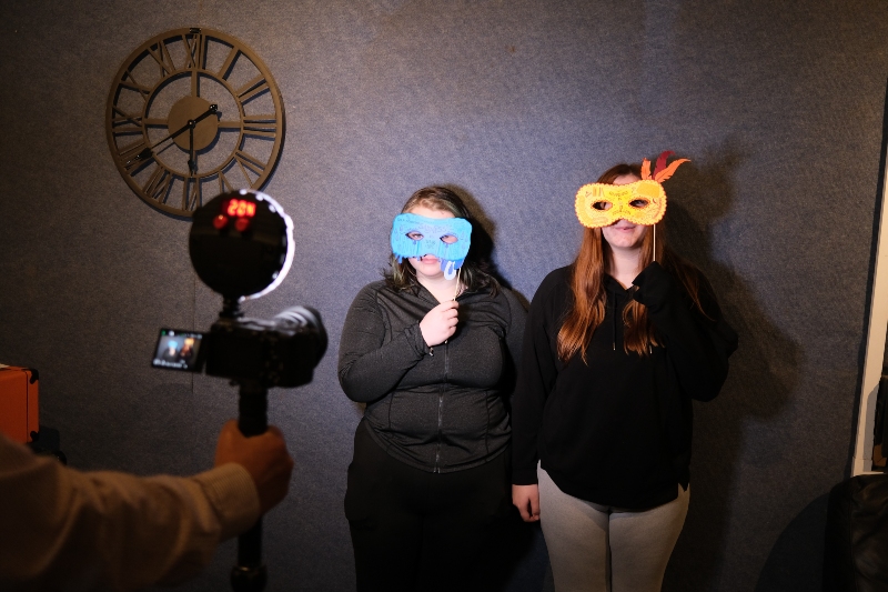 two young people wearing masks