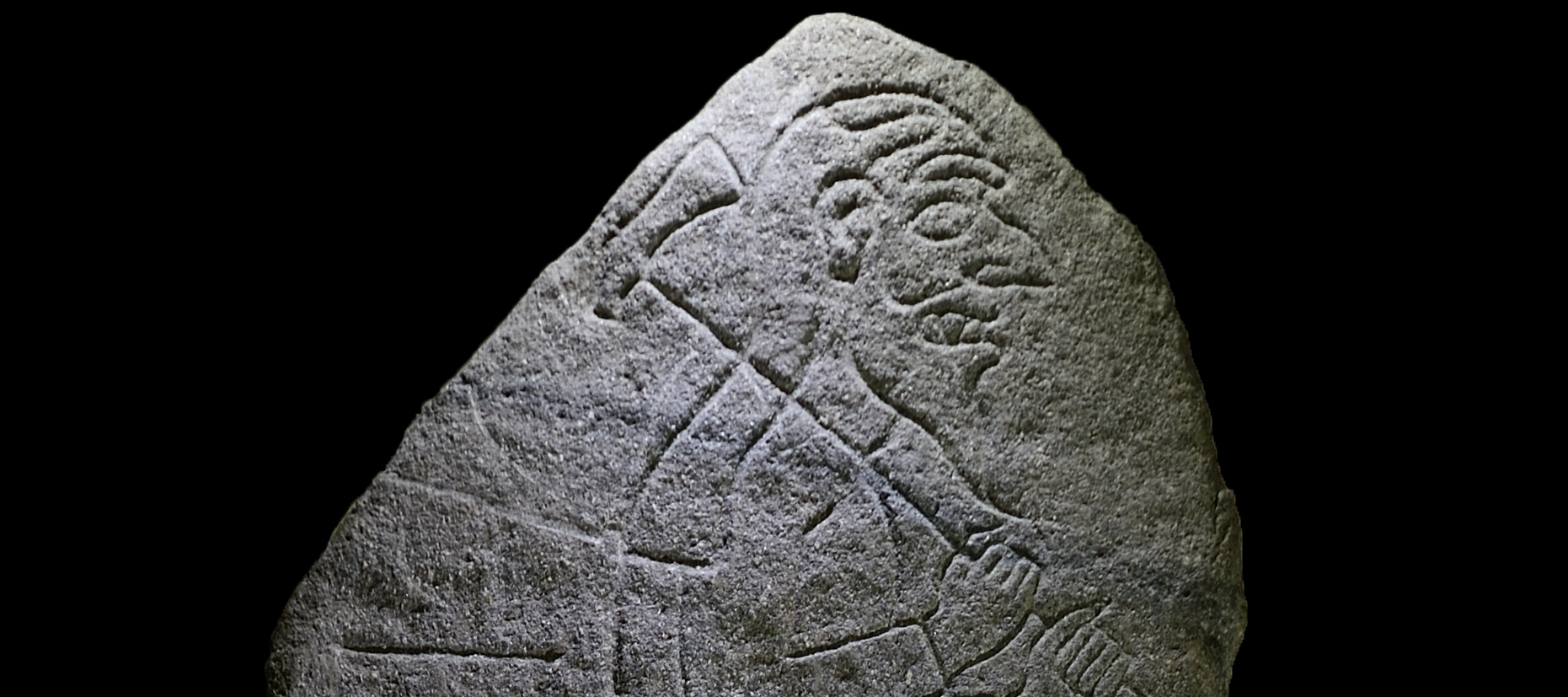 pictish carved image of a man with an axe over his shoulder