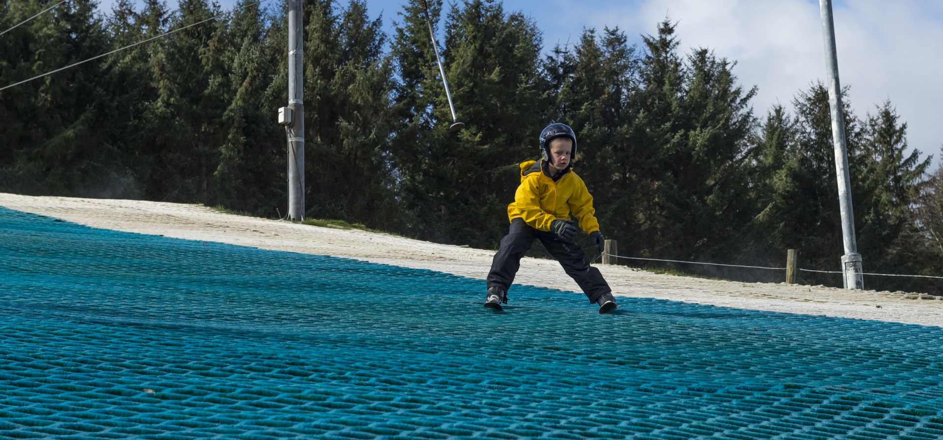 A person going skiing down a dry ski slope