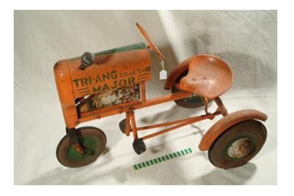 A metal, orange coloured child's toy sit on tractor