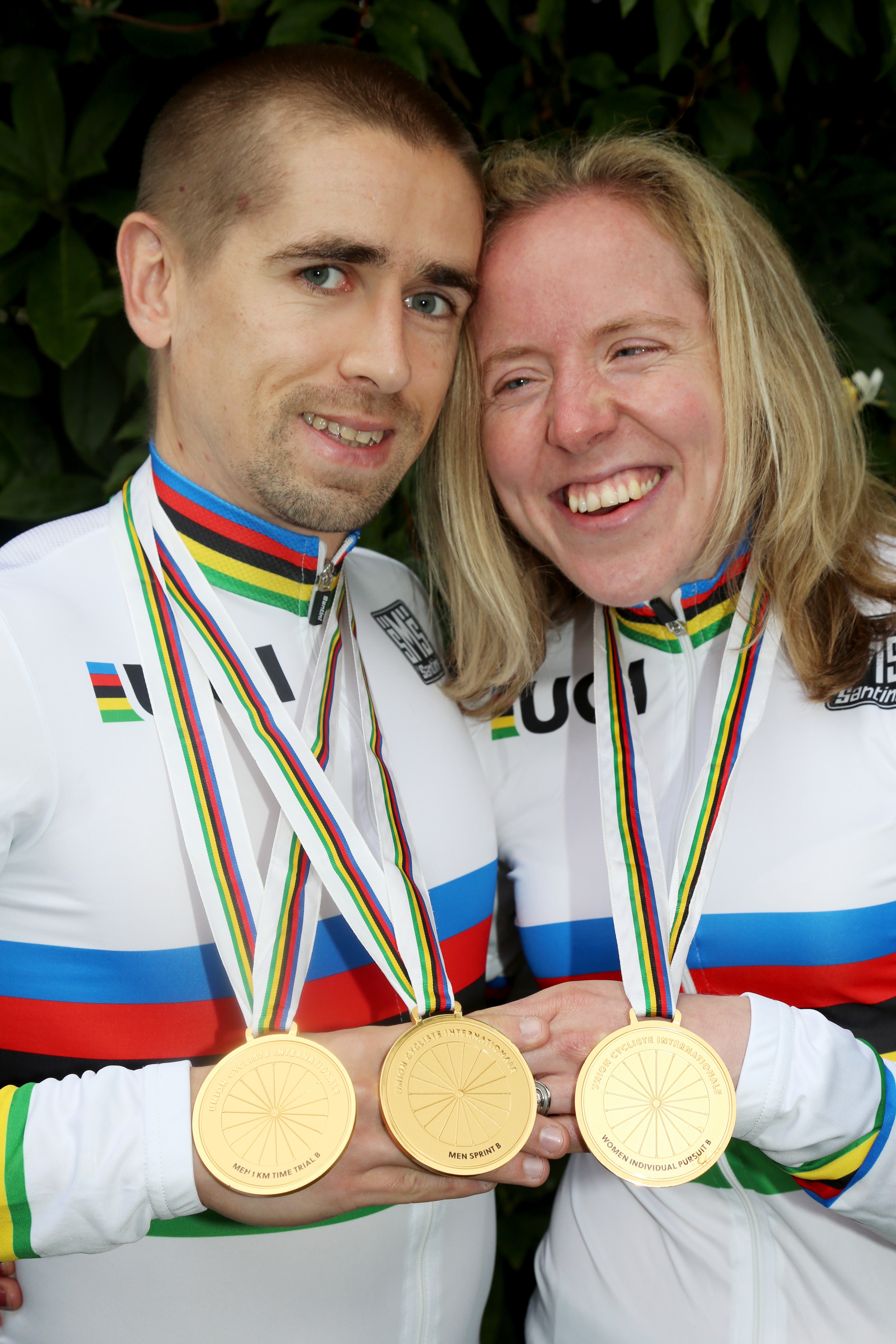 Neil and Lora Fachie holding various cycling medals.