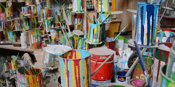A pile of colourful old paint cans