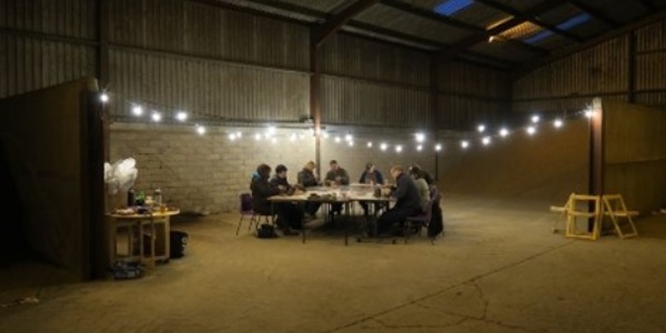 The artists working together round a table