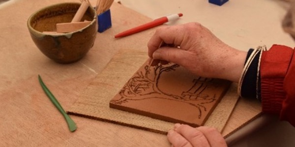 A close up of a person creating a piece of artwork