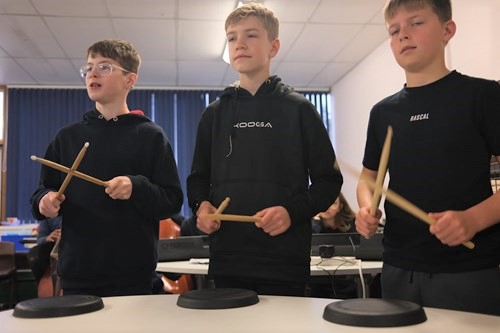 photo of three boys drumming