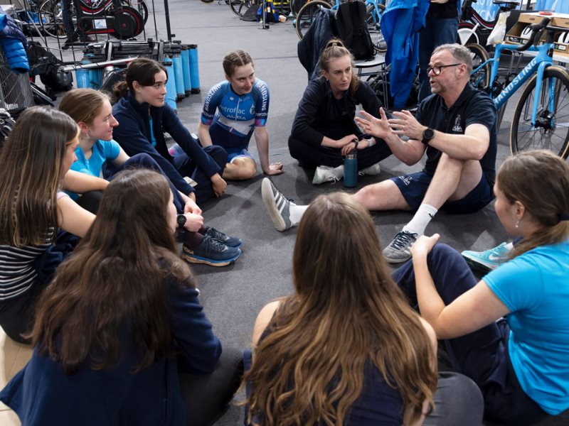 A group of people sitting in a circle discussing cycling